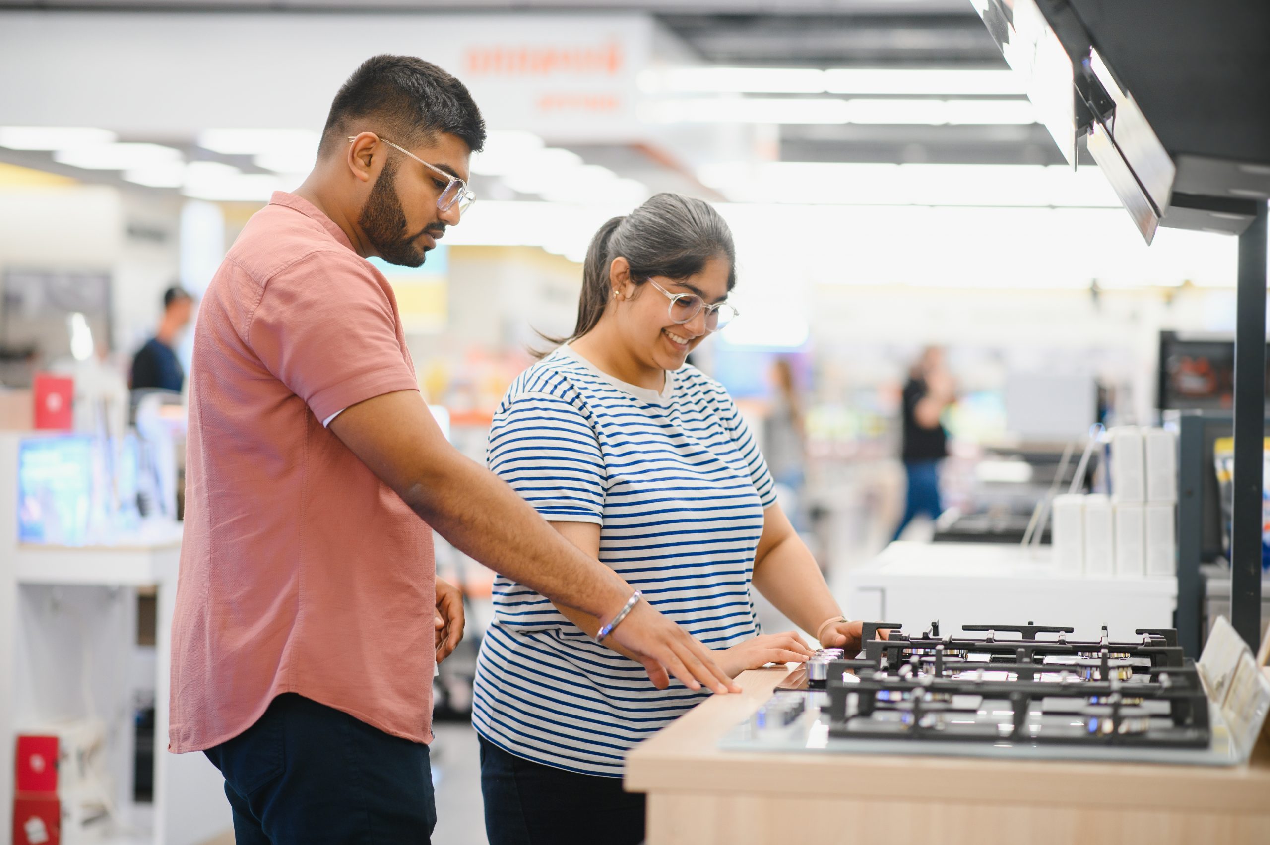 young-indian-couple-choosing-new-gas-stove-in-home-2026-01-09-06-24-17-utc-scaled