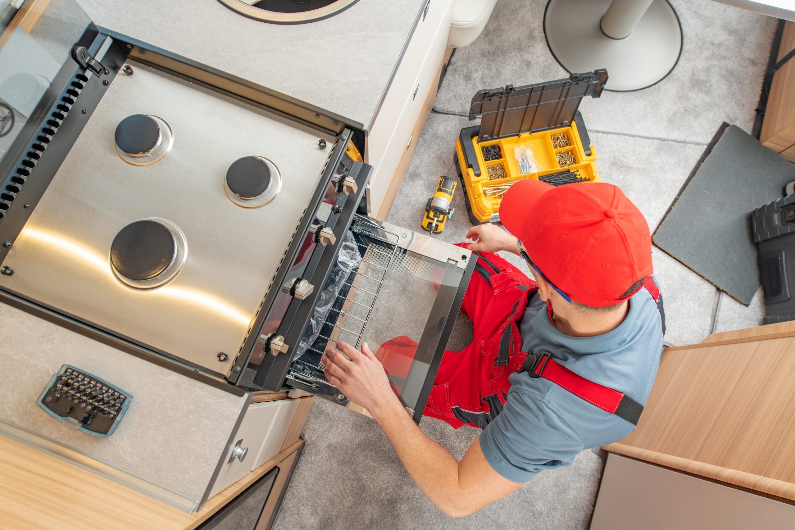 man-repairing-gas-stove-in-rv-kitchen-2026-03-25-02-18-26-utc-scaled